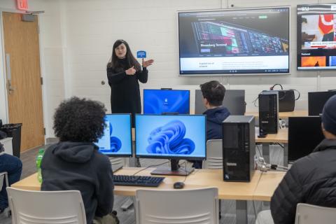 The new Finance & Data Analytics Lab in Parenzo Hall at Westfield State University, Jan 2025. A professor presents during class in front of a television while students watch and listen.