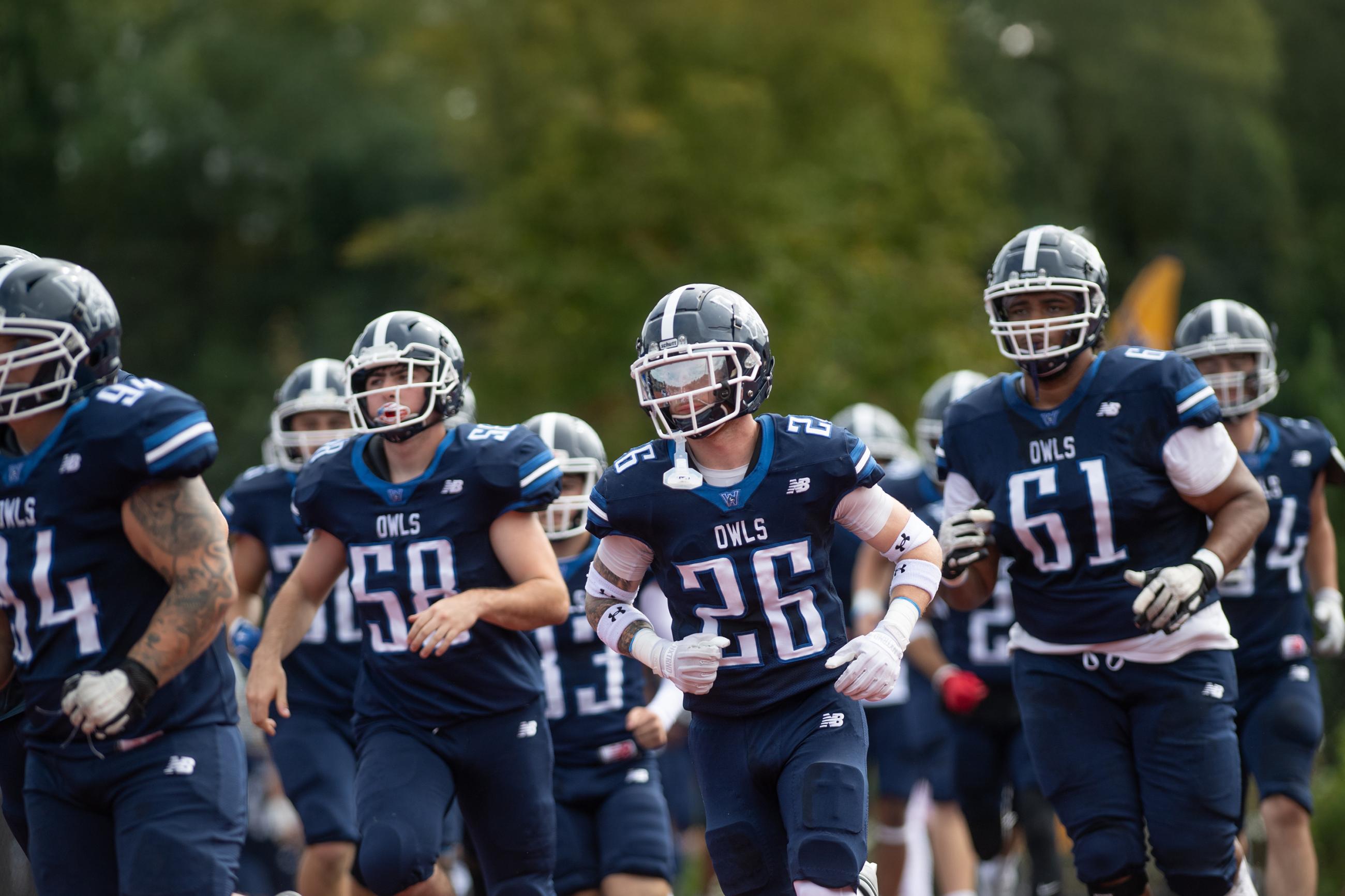 The Westfield State University Football squad runs on to the field before a game