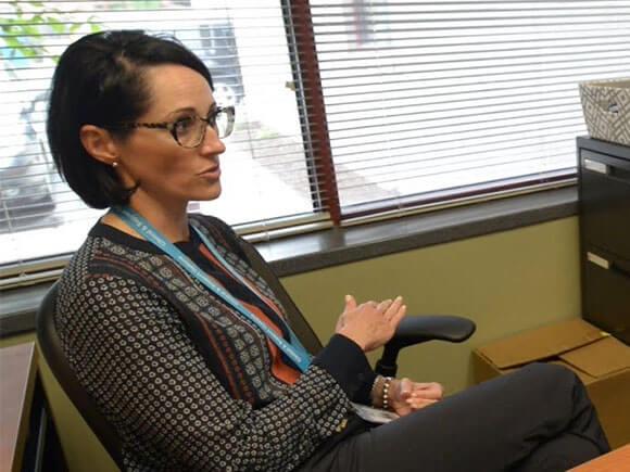 Christy O'Brien talking to patient in an office.