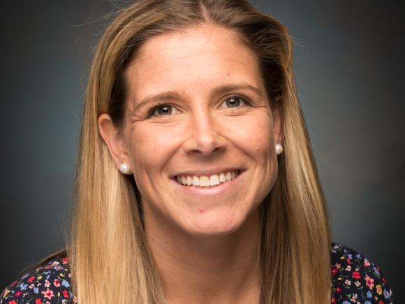 Dr. Lyndsey Nunes, Director of Inclusive Postsecondary Education at Westfield State University. It's a headshot, featuring a gray background behind her.