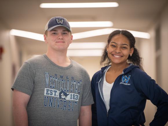 Two students smiling wearing WSU shirts.