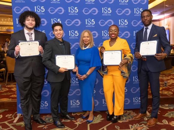  Keeper of the Dream Scholarship recipients and students of Westfield State: Catrina Casting, Bronwyn Pinsly, Mekhi Bowen, and Troy Thomas, alongside President Thompson.