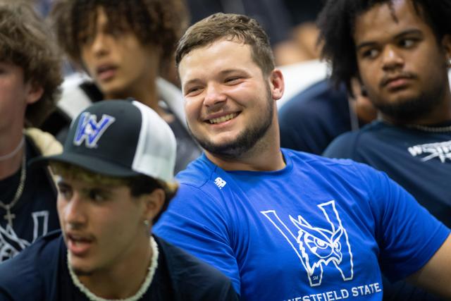 male student smiles at friends at the beginning of freshman convocation