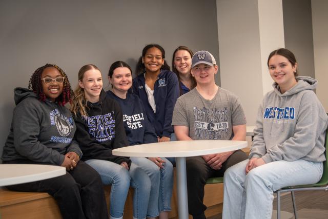 Group of students smiling wearing WSU shirts.