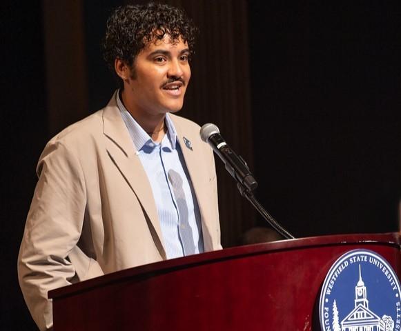 Psychology student speaking at a podium.