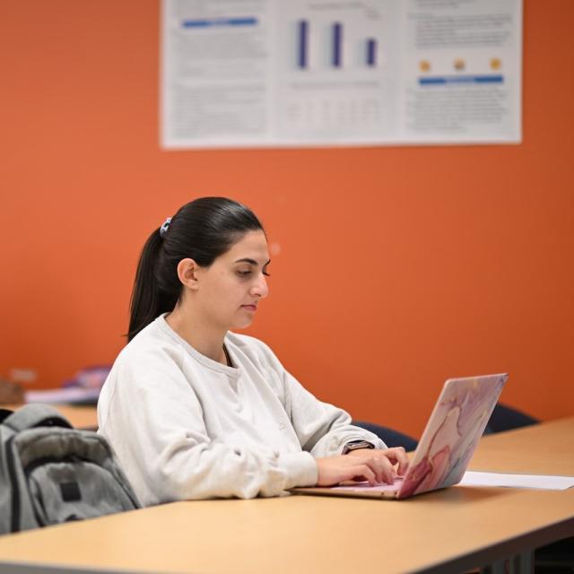 ABA student with a laptop in a classroom.