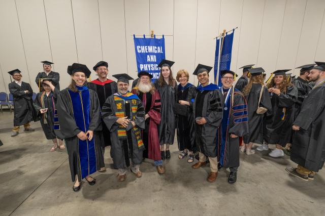 Chemical and Physical Sciences Department faculty smiling at commencement.