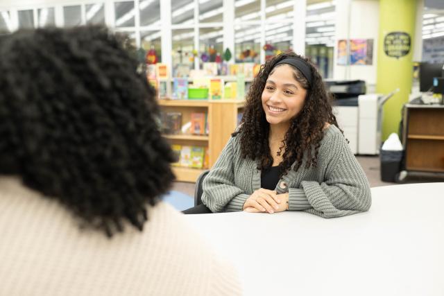 Student smiling at their internship at a local school.