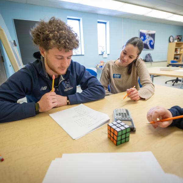 Math Tutoring Center tutor assisting a student with their homework.