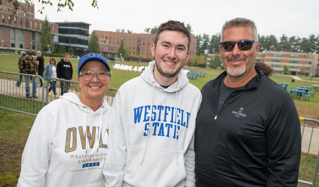 Families & Champions Weekend 2023 featuring a family of 3 smiling wearing WSU shirts.