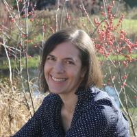 Faculty member Rebecca Olander smiling outdoors.